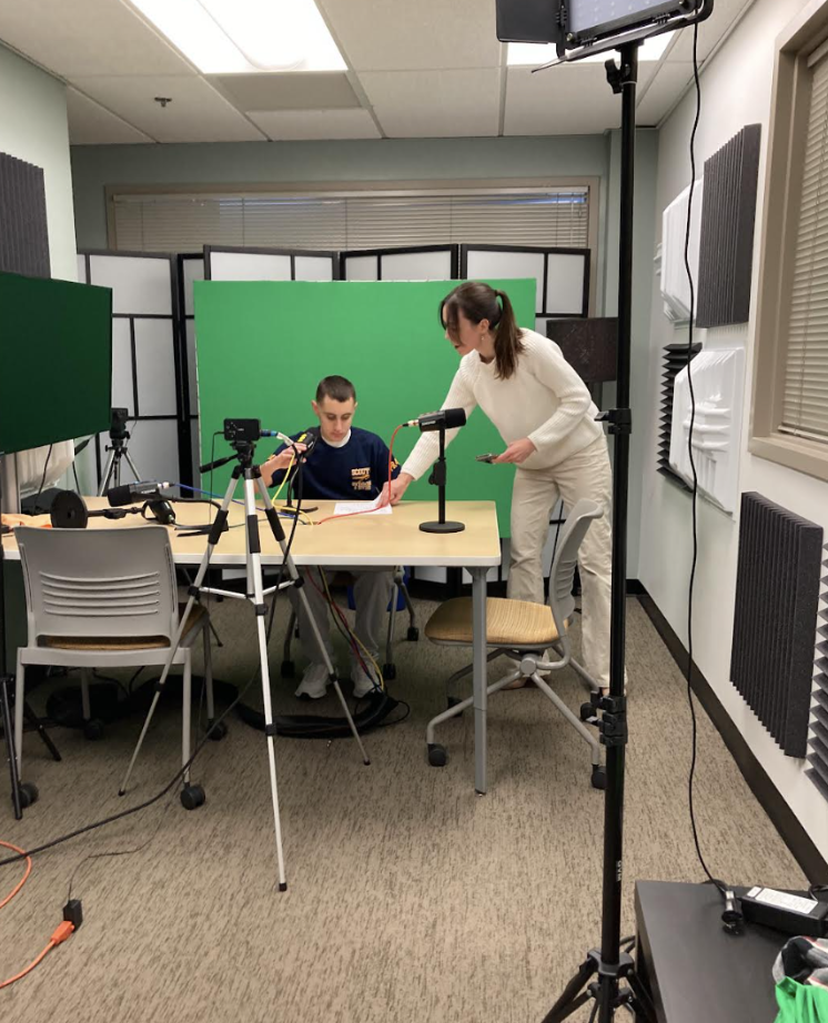 Ms. Laura Grigg with sophomore Will Hirschfield during the filming process.
